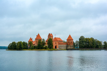 Fototapeta na wymiar Ancient castle on island in middle of lake. Trakai Island Castle historical landmark, Lithuania.