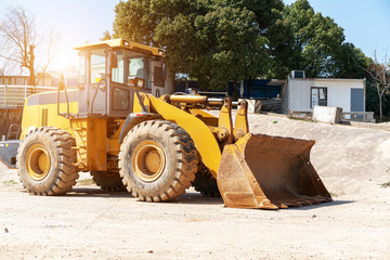 industrial building construction site mini bulldozer levelling and moving soil during highway building