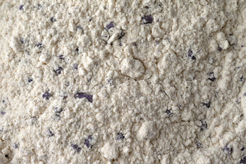 Very close view of clumpy blueberry muffin mix with imitation blueberries.