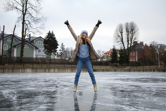 Woman with hands apart on rink