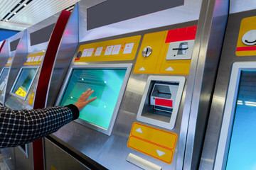 finance, money, bank and people concept - close up of hand entering pin code at atm machine