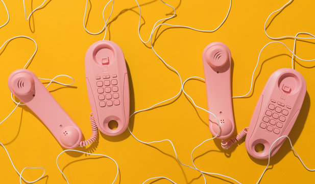 Pink telephones with messy cable