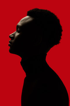 African American man portrait profile silhouette isolated over red - Eyes closed