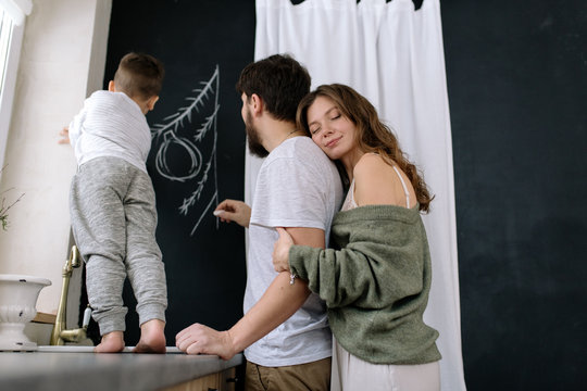Family drawing on walls with chalk
