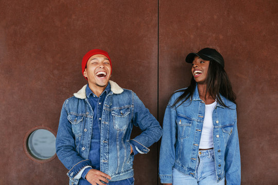 Portrait of happy cool couple wearing denim clothes.