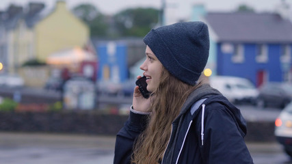 Fototapeta premium Young beautiful woman takes a phone call