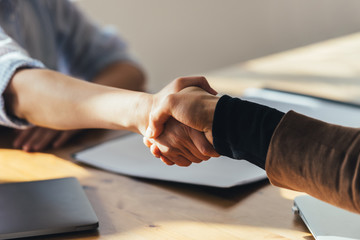 Businessman and businesswoman holding hands