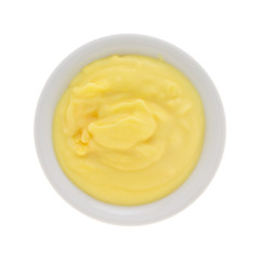 Top view of homemade banana cream pudding in a small bowl isolated on a white background.