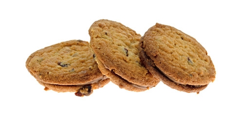 Three cranberry and oat cookies in a row isolated on a white background.