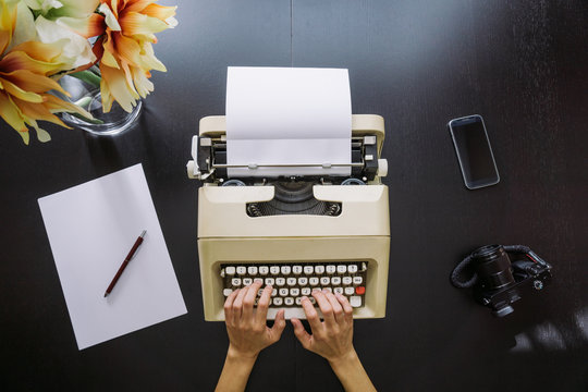 Woman typing on a typewriter