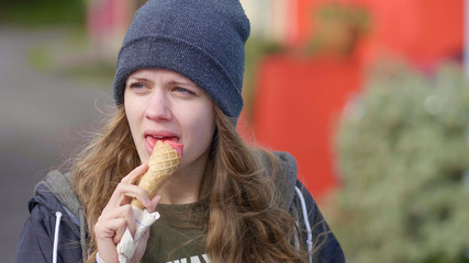 Close up shot of a young pretty woman eating ice cream - Powered by Adobe