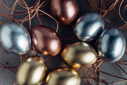 Close up of metallic eggs in a wire nest