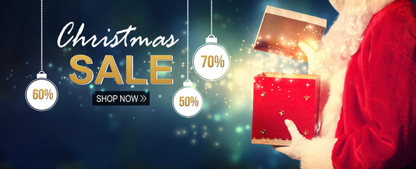 Christmas sale message with Santa opening a gift box on a shiny light background