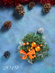 Christmas wreath on blue background and inscription 2019