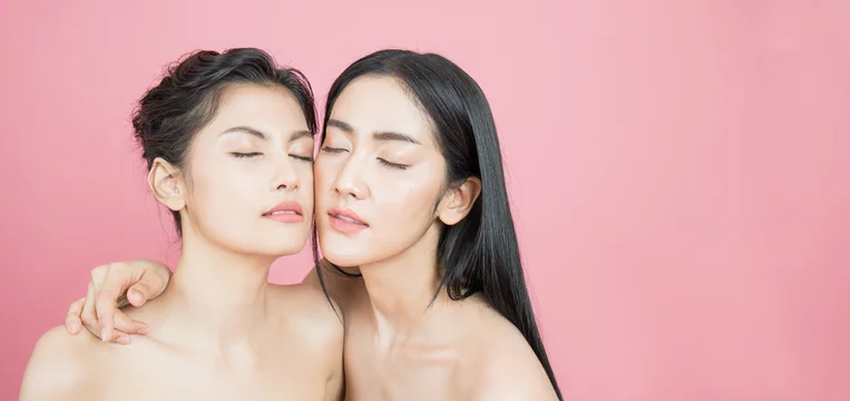 Closeup portrait of two young beautiful sexy asian woman isolated on pink  background. Beauty healthy skincare friendship lesbian girl concept banner  Stock Photo | Adobe Stock
