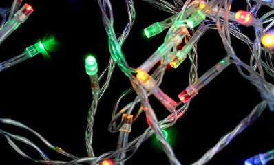 Christmas garland is burning on a black background.