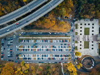 Top view photo of parking lot near bridge of road junction and city park taken by drone - Powered by Adobe