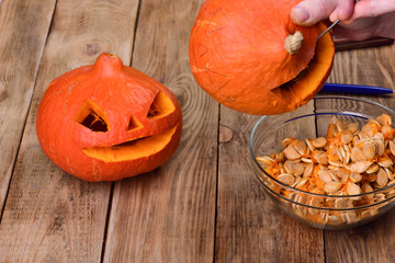 Scraping another pumpkin. Making a pumpkin lantern for Halloween