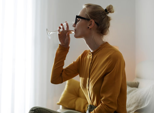 Woman drinking wine and chilling at home