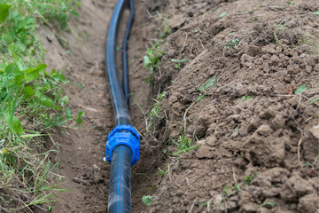 the water pipe lies in the excavated trench of the earth