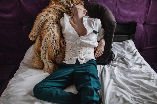 Sensual portrait of male model wearing corsete