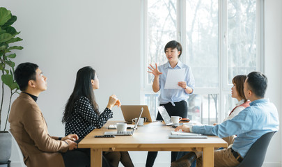 Businesswoman leading meeting in conference room