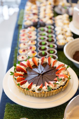 Chocolate cake with sliced strawberry on top on table