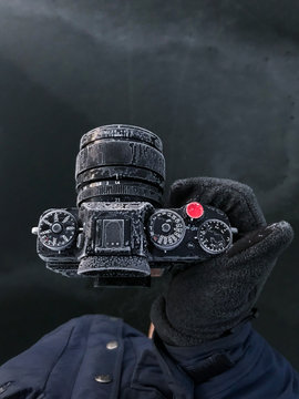 Photographer holding frozen camera