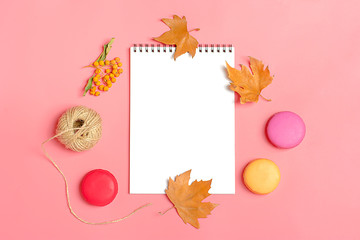 Dry maple leaves, macaroons and white notepad on yellow background Autumn concept To do list Mock up Top view Flat lay Copy space Hello September, October, November