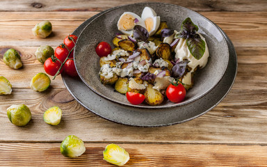 Roasted Brussels sprouts with cheese Dor Blue, egg and red onion.