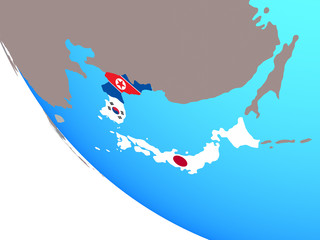 Fototapeta premium Japan and Korea with national flags on simple globe.