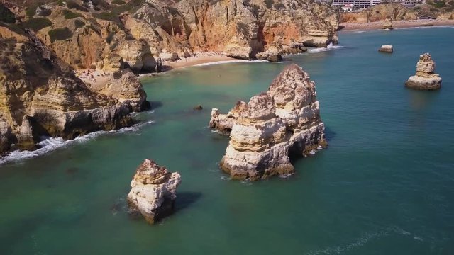 4k drone - Cliffs and rock formations of Praia do Camilo Beach. Lagos, Portugal.  Algarve.
