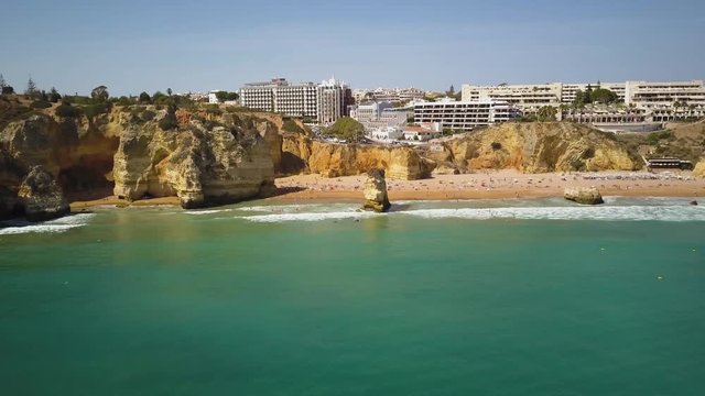 4k drone - Cliffs and rock formations of Praia Dona Ana beach.  Lagos, Portugal.  Algarve