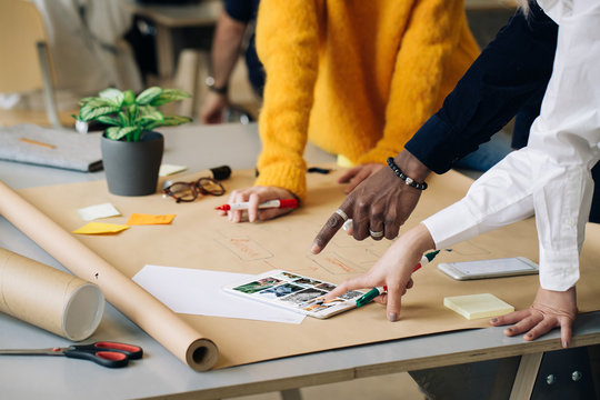 Group Of Young Faceless Agency Co-Workers Working On Website Con