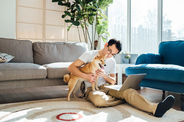 Man using laptop with dog