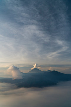 A volcano erupting in the distance