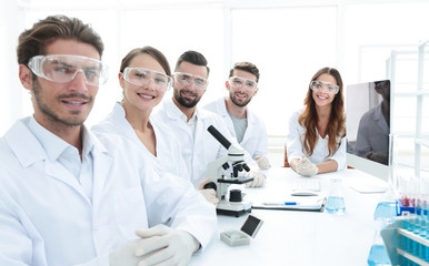 Male scientist and the team in the lab.