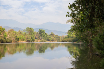 Scenic view of the Nam Song River near Vang Vieng, Vientiane Province, Laos, on a sunny day.