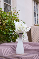  Bouquet of white chrysanthemum in a white vase on the table