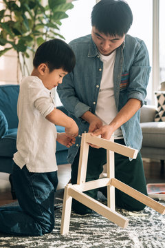 Father and son working on carpentry at home