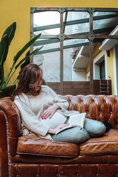 Portrait of a pregnant woman reading