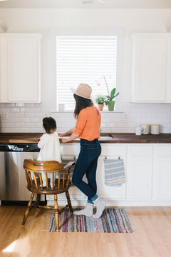 Baby Helping Mom In The Kitchen