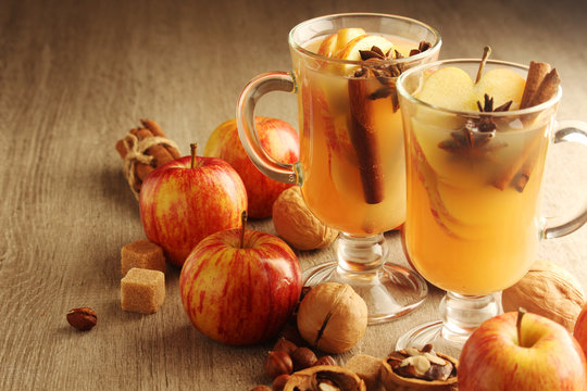 Two cups with hot cider in cold season with cinnamon and anise