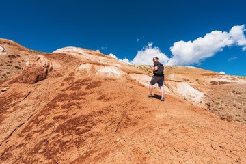 Tourist with a backpack goes up the hill