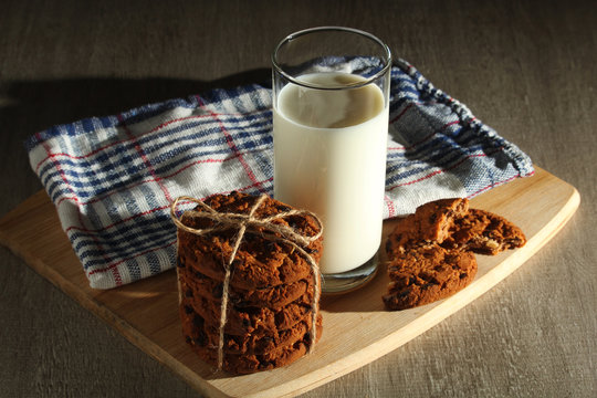 A glass with milk and chocolate cookies