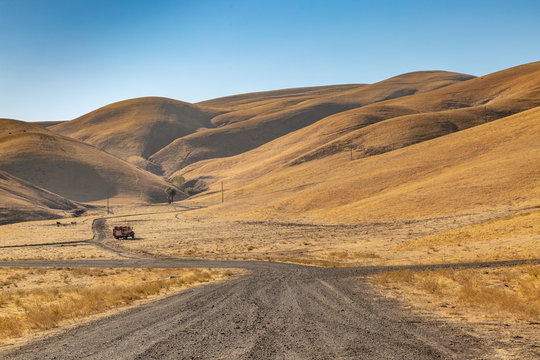 A firetruck in the parched Californian countryside, with a clear sky overhead