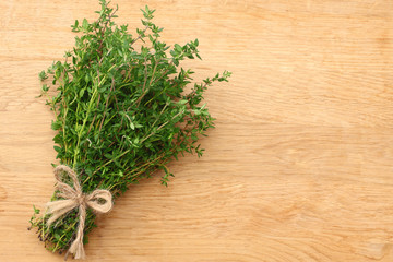 Thyme bunch on wooden background. top view