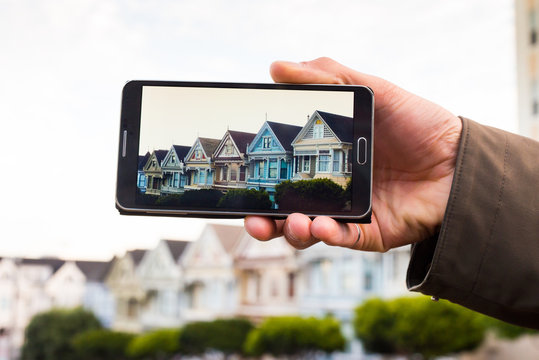 Smartphone screen displaying row of homes on a San Francisco hil