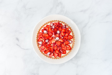 Top view of a Strawberry Tart on white Marble