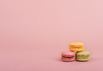 Deliious juicy makaroner, on beige color cappuccino background.